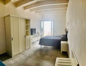 a bedroom with a bed and a room with a window at Hotel Boutique Il Castellino Relais in Vieste