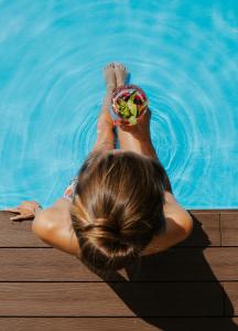 a woman laying in the water in a pool at OREA Resort Santon Brno in Brno