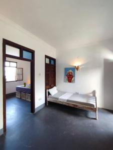 a large bedroom with a bed and a mirror at zLife Stone Town in Zanzibar City