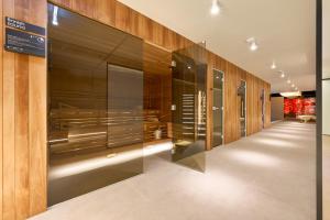 a dressing room with wooden walls and glass doors at Grand Hotel View in Postira