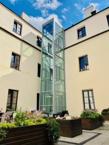 a glass elevator in the side of a building at Dom na Podwalu in Lublin