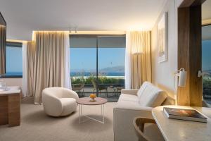 a living room with a couch and chair and a table at Grand Hotel View in Postira