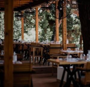 a group of tables and chairs in a restaurant at Trikorfo Bungalows in Gerakini