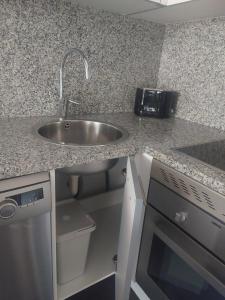 a kitchen with a sink and a counter top at BRICIA APARTAMENTO 16 in Llanes