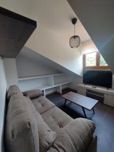 a living room with a couch and a table at Aldea Bricia 16 in Posada de Llanes
