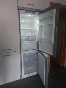 an empty refrigerator with its door open in a kitchen at Aldea Bricia 16 in Posada de Llanes