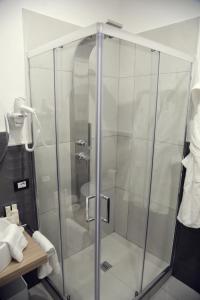 a shower with a glass door in a bathroom at B&B Les Lumières in Salerno