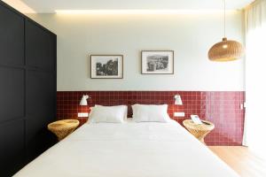 a bedroom with a large bed with red tiles at Quinta de São Luiz The Vine House in Tabuaço