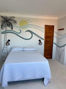 a bedroom with a bed with a palm tree mural at Sunshine - Casa de praia em Barra Grande -Ba in Barra Grande +46 photos