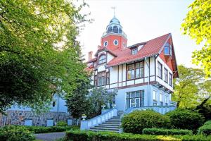 a large house with a tower on top of it at Rewita Rusałka in Sopot