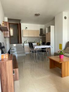a kitchen and living room with a table and chairs at Aurora in Pag