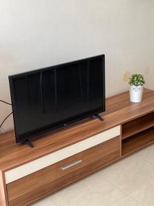 a flat screen tv sitting on top of a wooden entertainment center at Aurora in Pag