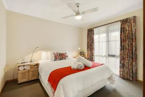 a bedroom with a large bed and a window at Summerfield Winery and Accommodation in Moonambel