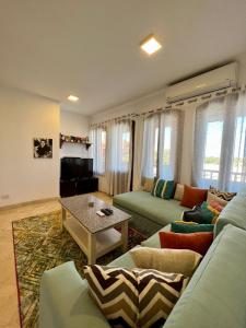 sala de estar con sofá y mesa en Taj Home, Amazing pool and lagoon view 2bedrooms apartment, en Hurghada