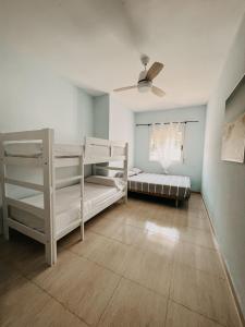 a room with two bunk beds and a ceiling fan at Apartamentos Venta Lanuza, El Campello in El Campello +52 photos