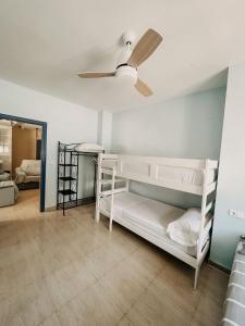a room with two bunk beds and a ceiling fan at Apartamentos Venta Lanuza, El Campello in El Campello
