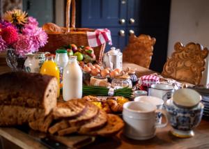 a breakfast table with eggs and bread and toast at Country Cottage with Spa, Catering, Gardens, Nature Reserve Walks - Free Parking, Self Checkin in Scunthorpe