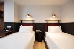 Postel nebo postele na pokoji v ubytování Monocolo Boutique Hotel