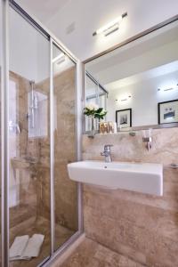 a bathroom with a sink and a shower at Mondial Resort & Spa in Marina di Pietrasanta
