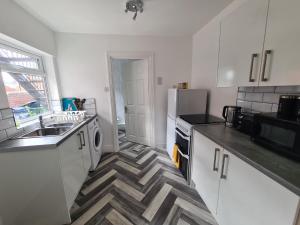 a kitchen with a sink and a stove top oven at 5 bed sleeps 6, 2 miles (7 mins) from city centre in Low Team