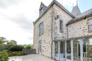 an external view of a house with large glass doors at Grande maison de charme, 14 pers. 5 chambres, sauna, écrin de verdure, baby foot in Saint-Clémentin