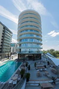a large building with a swimming pool in front of it at White Tower Mamaia Apartament Privat 503 in Mamaia