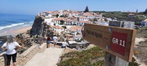 a sign on a mountain with people walking on it at Casa Mateus - Colares, Parque Natural Sintra Cascais in Sintra