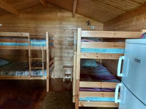 a room with two bunk beds in a cabin at Vanasauna Guesthouse in Valma