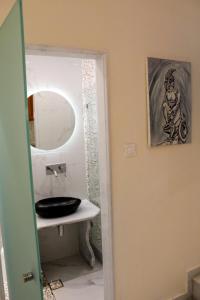 a bathroom with a sink and a mirror at Sea View Studios & Apartments in Agia Anna Naxos