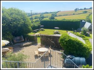 an aerial view of a garden with tables and umbrellas at The Poltimore Inn in North Molton