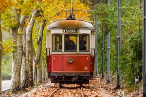 a red and white trolley car on the tracks at Casa Mateus - Colares, Parque Natural Sintra Cascais in Sintra