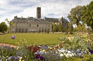 a large building with flowers in front of it at ibis budget Limoges Centre Gare in Limoges