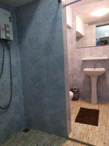 a bathroom with a shower with a toilet and a sink at Hooman Hostel in Chiang Mai +21 photos