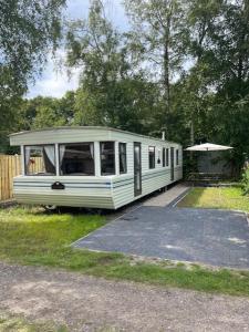 a white train car parked in the grass at Chalet Westmoreland in De Pol