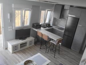 a kitchen with a table and chairs in a room at ZARAPITO in Chiclana de la Frontera