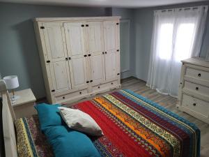 a bedroom with a bed and a large cabinet at ZARAPITO in Chiclana de la Frontera