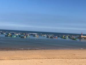 a group of boats in the water near a beach at Dar SAADA maison de sylvie in Souira Guedima