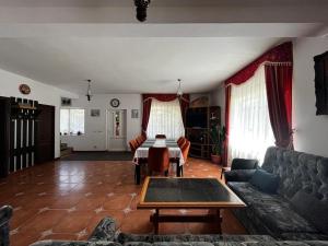 a living room with a couch and a table at Casa Jasmin in Bran