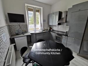 a small kitchen with a table and a tableablish at Eva's Hostel - Self Check-In & Only Private Rooms in Düsseldorf