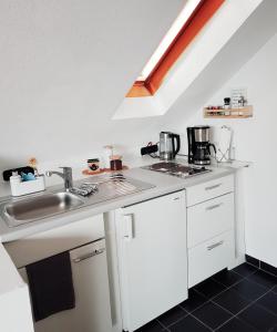 a kitchen with a sink and a counter top at Casa Blanca in Niestetal +4 photos