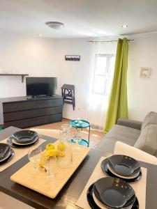 a living room with a table with plates and glasses at Tower House Vodice in Vodice