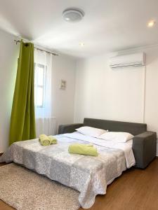 a bedroom with a bed with two towels on it at Tower House Vodice in Vodice