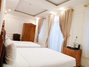 מיטה או מיטות בחדר ב-Khách sạn Le Royal