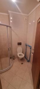 a bathroom with a toilet and a glass shower at Eve Santa Marina Studios - sea, pools, relax in Sozopol +40 photos