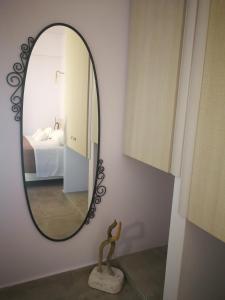 a mirror on a wall in a bedroom at APARTMENTS BY THE SEA in Gázion