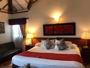 Cama o camas de una habitación en Hotel Santa Viviana Villa de Leyva