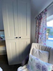 a bedroom with a white cabinet and a pillow at Beautiful Cottage in the Yorkshire Dales in Leyburn