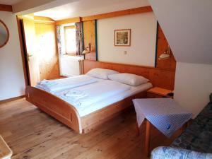 a bedroom with a large bed in a room at Landhotel Lacknerhof in Mariapfarr