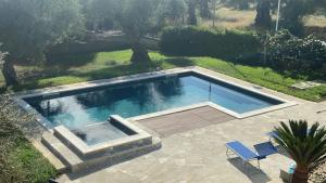 a swimming pool in a yard with two chairs at B&B Oliveto in Caserta