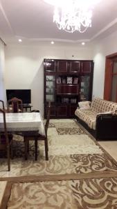 een woonkamer met een tafel en een bank bij Apartment at Narimanov 151 in Ganja